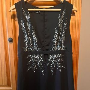 BEBE AMAZING black dress. Low cut with beautiful stone detail.